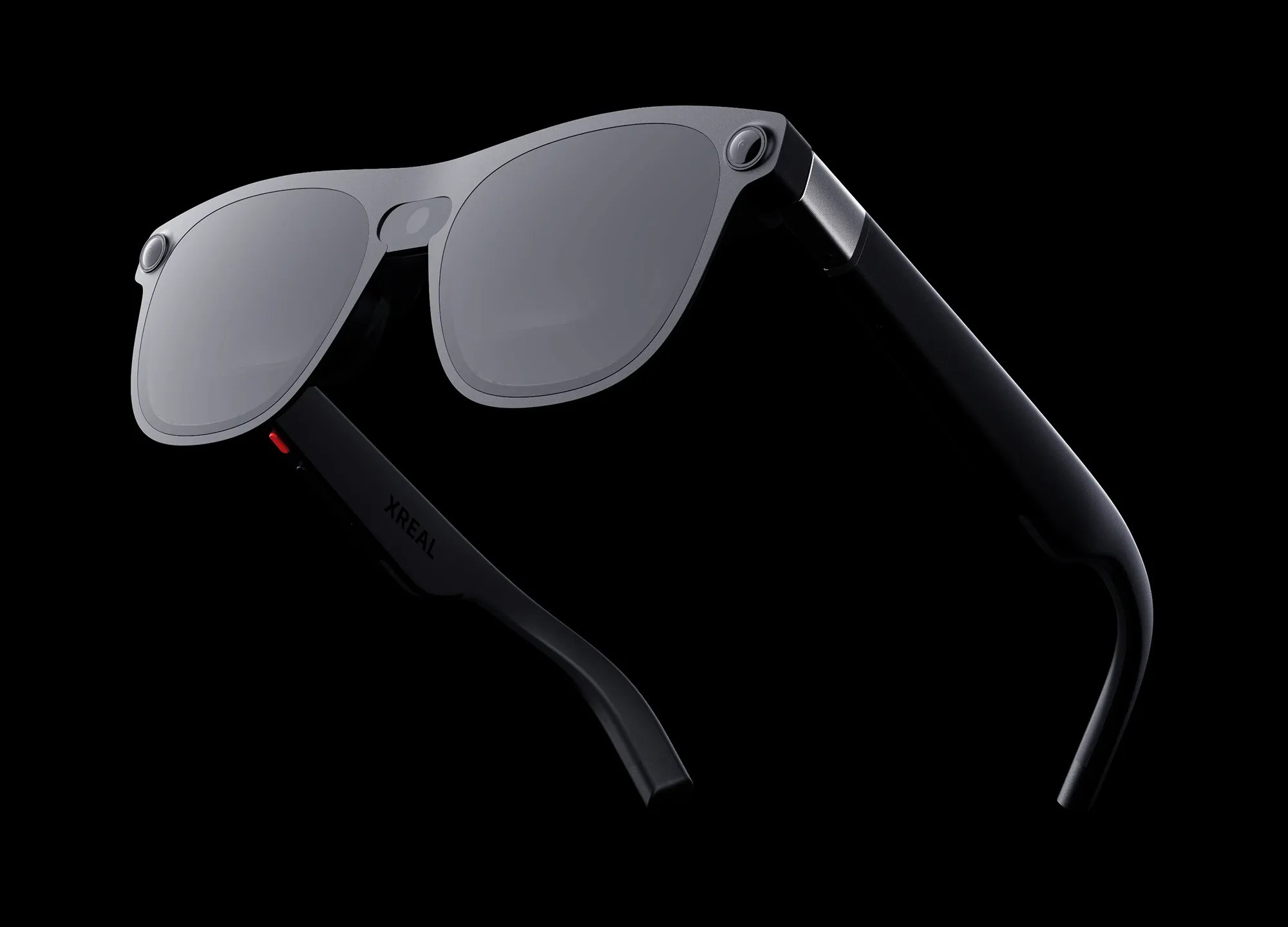 XREAL Aura glasses with dark lenses, photographed at an angle on a black background