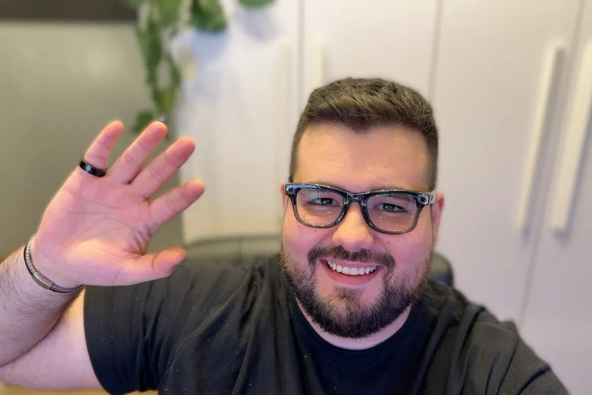 Me at my desk with the ring on my pinky and the Ray-Ban Meta glasses on