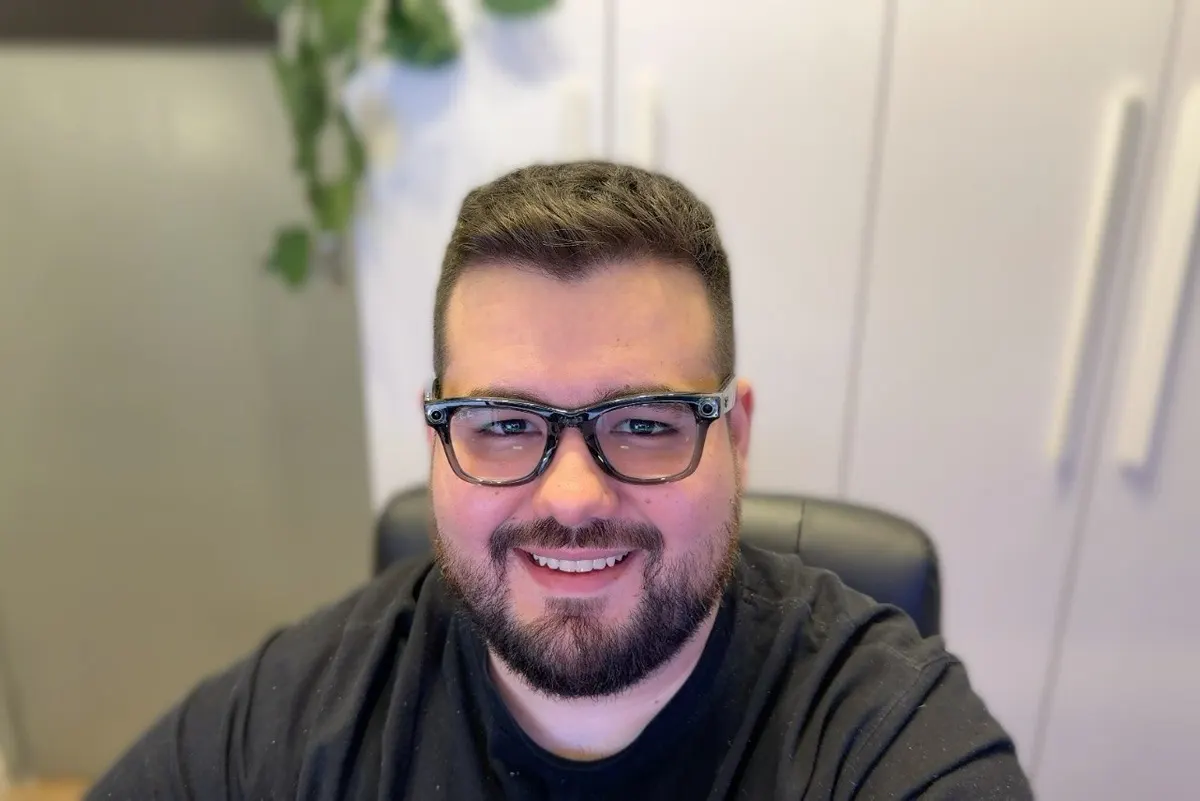 Me wearing the Wayfarers at my desk, lenses clear indoors